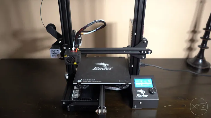 Creality Ender 3 3D printer on a dark wooden desk
