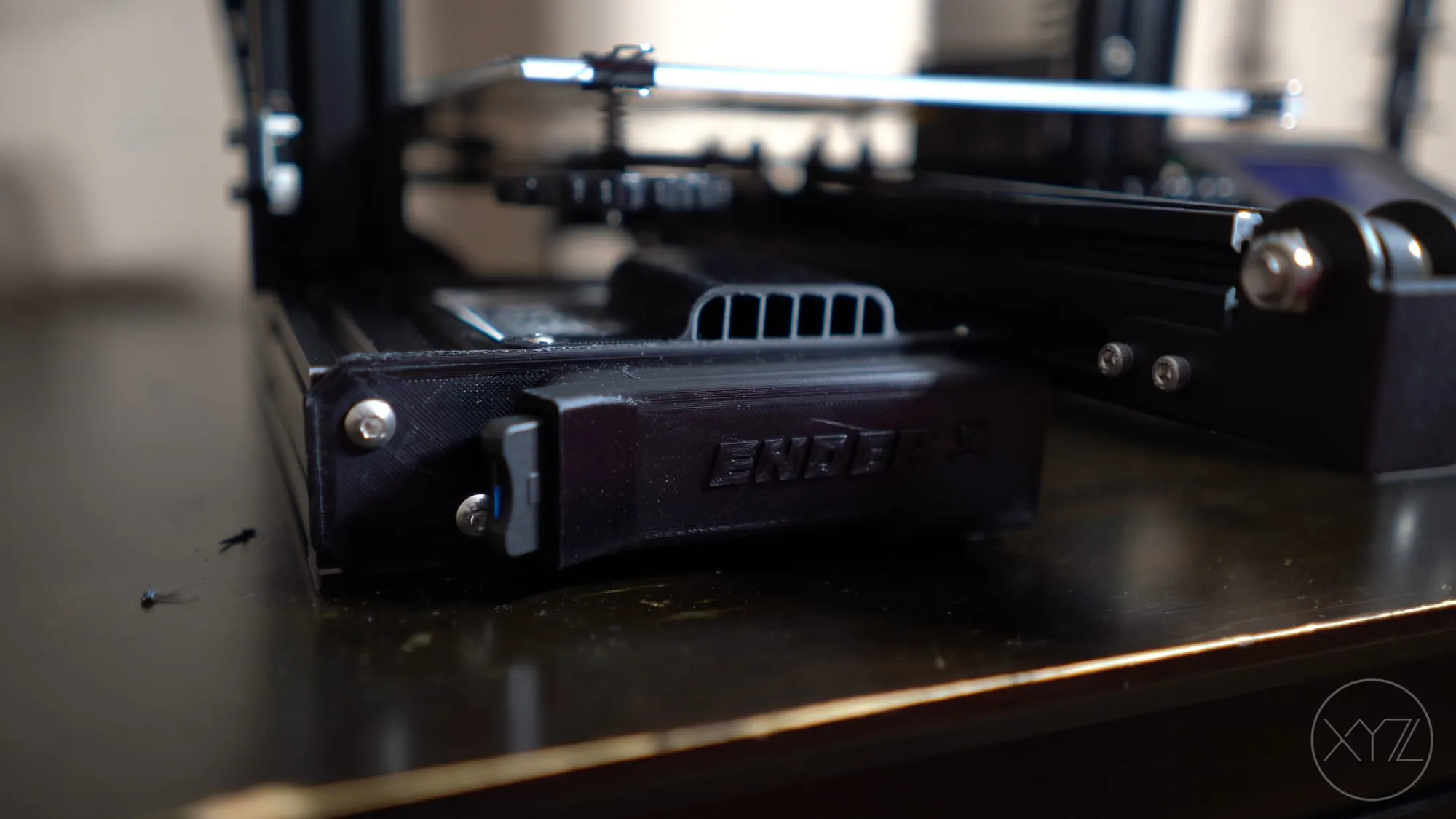 Printed fan guard and cable holder under the Ender 3 heat bed