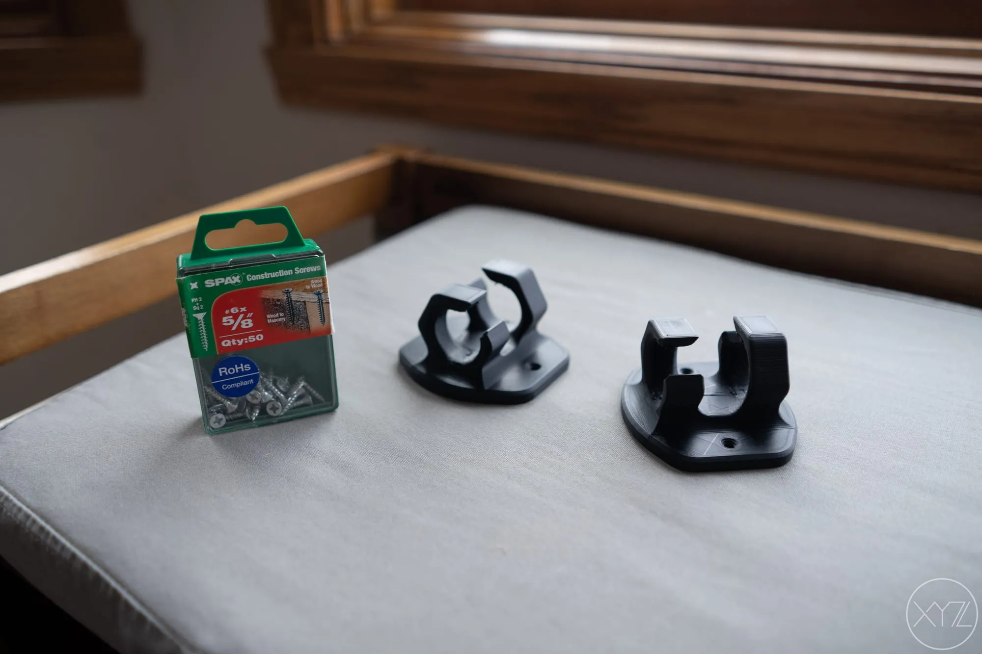 Two 3D printed hexagonal cable routing clips